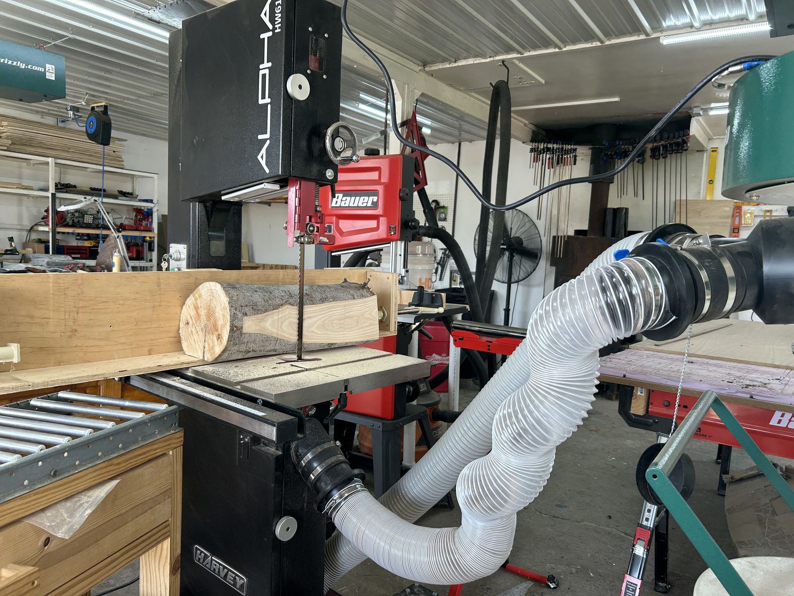 Resawing a log on the bandsaw in the Resonance Woodcraft shop