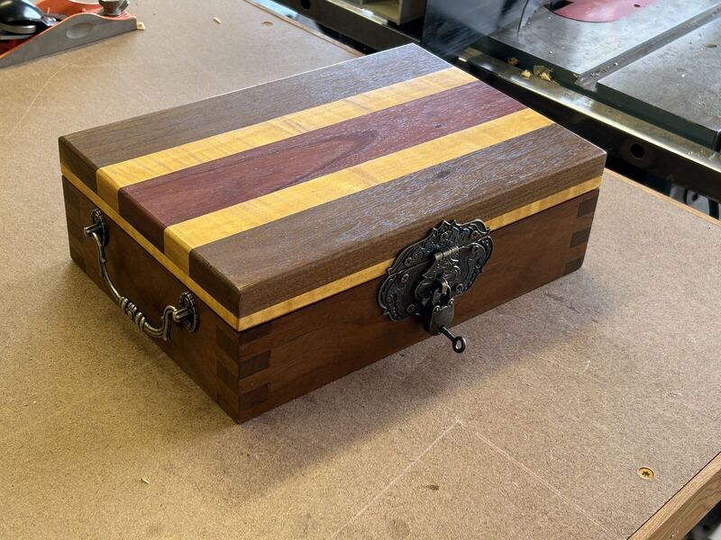 Wooden keepsake box with striped lid and antique latch