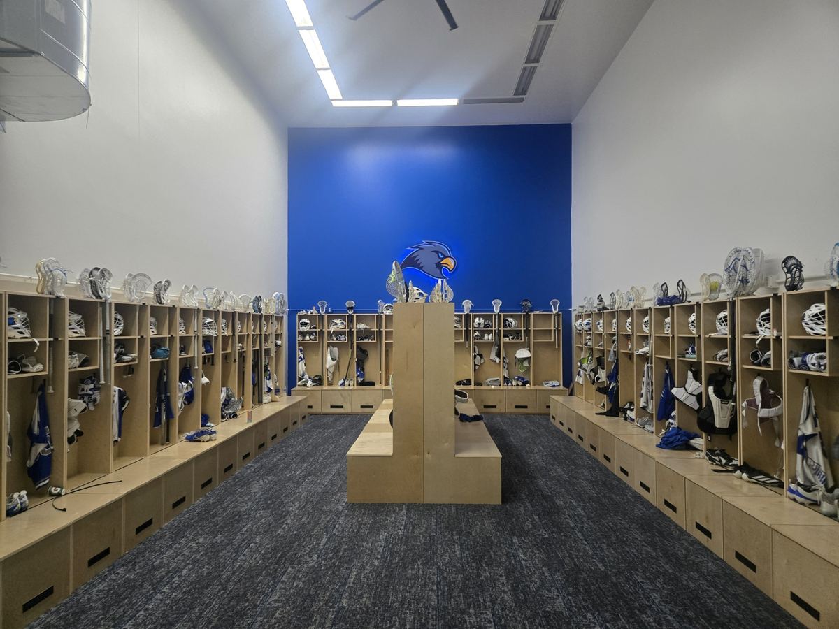 Lacrosse locker room lined with birch lockers and center benches